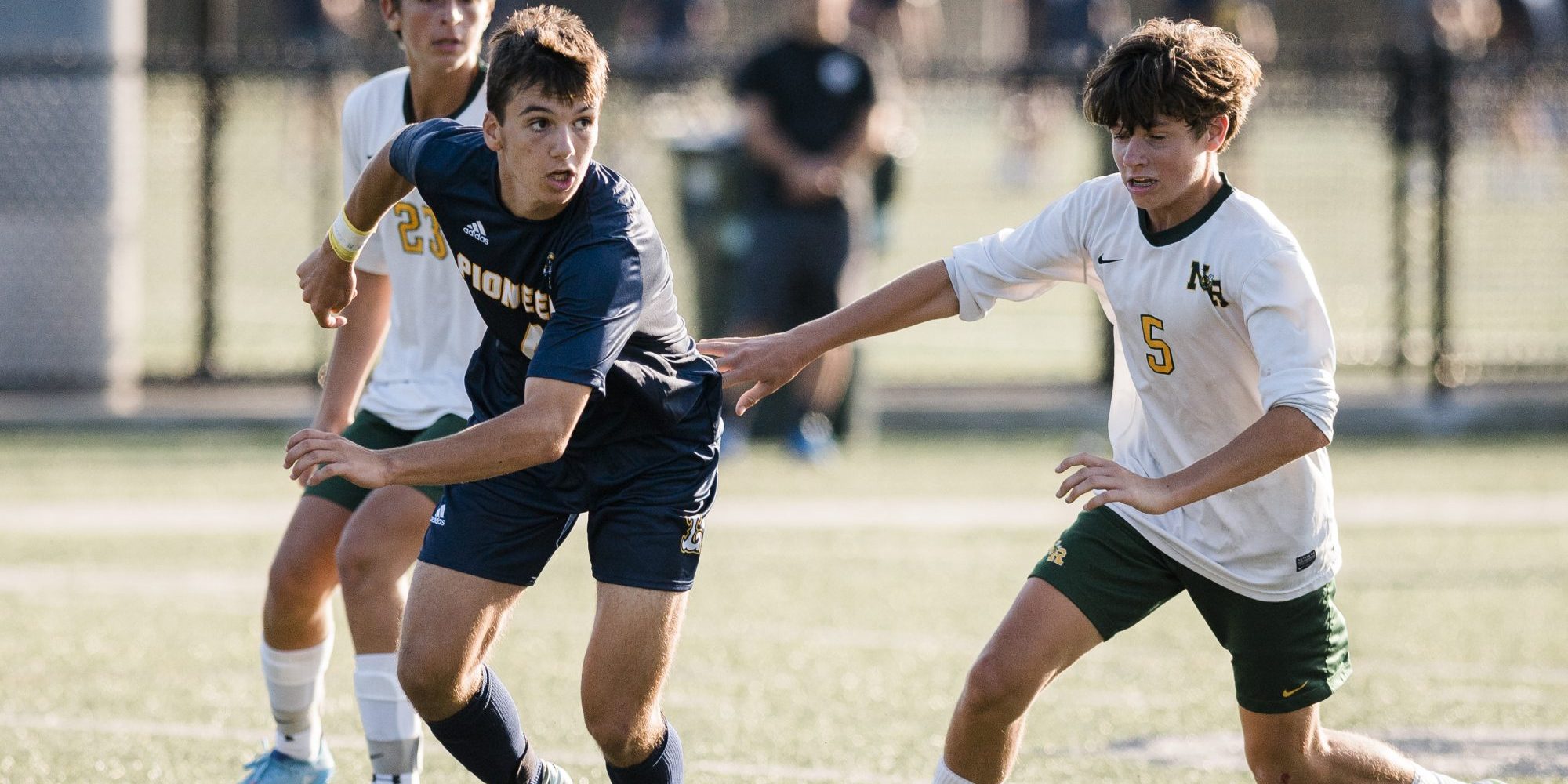 Lynnfield's Alex Gentile works the ball around North Reading's Finn