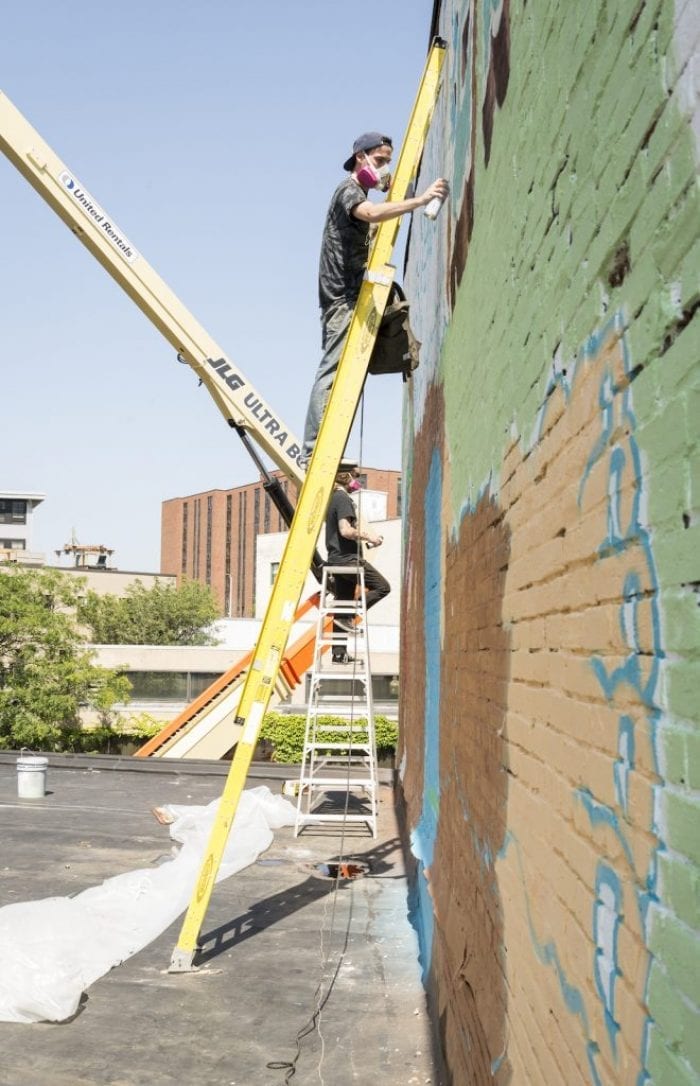 Tallboy, below, and Brian Denahy are making progress on their mural at 465 Washington St.