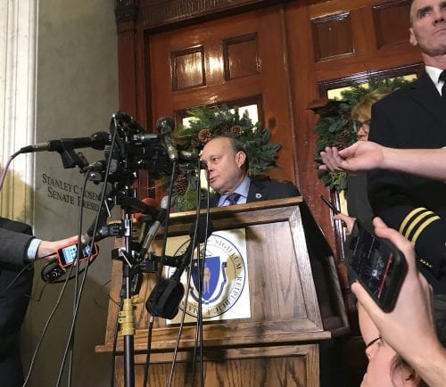Massachusetts Senate President Stan Rosenberg speaks from behind a podium outside his office at the Statehouse to a throng of media Friday, Dec. 1, 2017, in Boston.