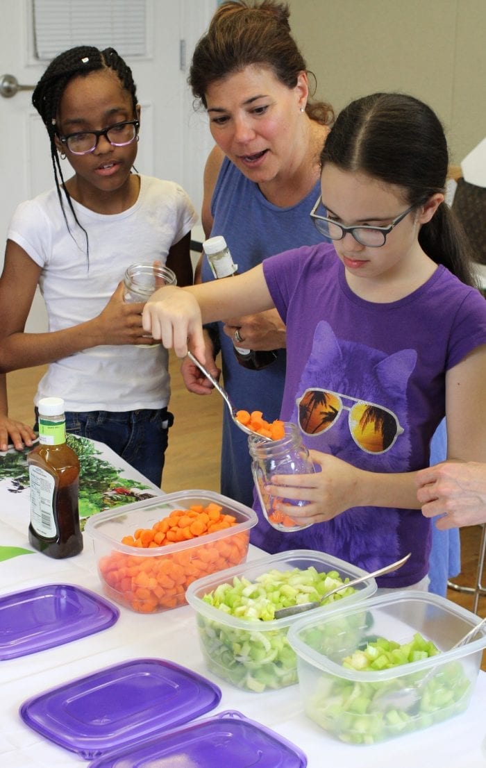 Lynn, Ma. 5-3-18. Laisha Mercedes, Christine Meninno and Jasmin Guzman begin to build a salad in a jar at Girl's Inc.