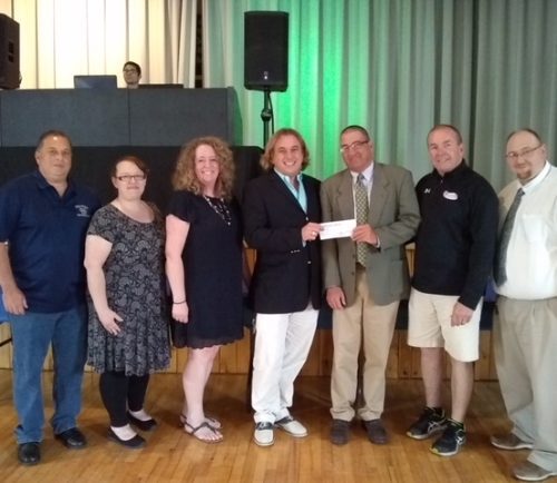 The Peabody Performing Arts Parents Group donated $2,000 to Northeast Arc's campaign to outfit Peabody's Black Box Theater. Pictured are John Sacramone (left), President, Vocal Music Parents; Laurie Bratt, President, Peabody Instrumental Parents; Kelley Bresnahan, President, Stage One Association of Patrons and Treasurer of the Higgins Middle School Performing Arts Parents Group; Tim Brown, Director of Innovation and Strategy at Northeast Arc; Richard Carey, Stage One Director; Tom Gould, Chairman, Friends of the Black Box; and Jason Jones, Band Director. Not pictured, Jon Simmons, Director of Performing Arts, Peabody Public Schools.